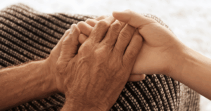 Elder holding a youth's hands